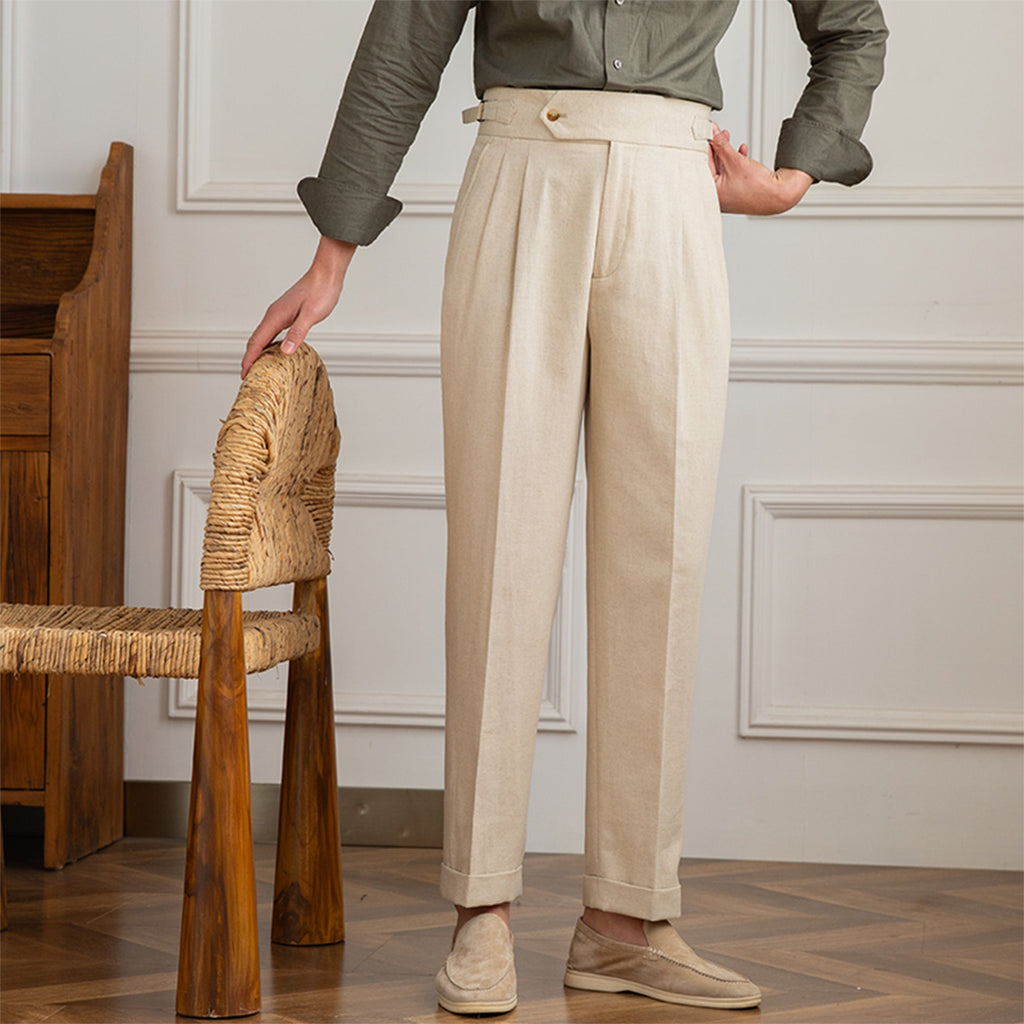 Model wearing high-waisted pleated trouser in beige – TARLANO